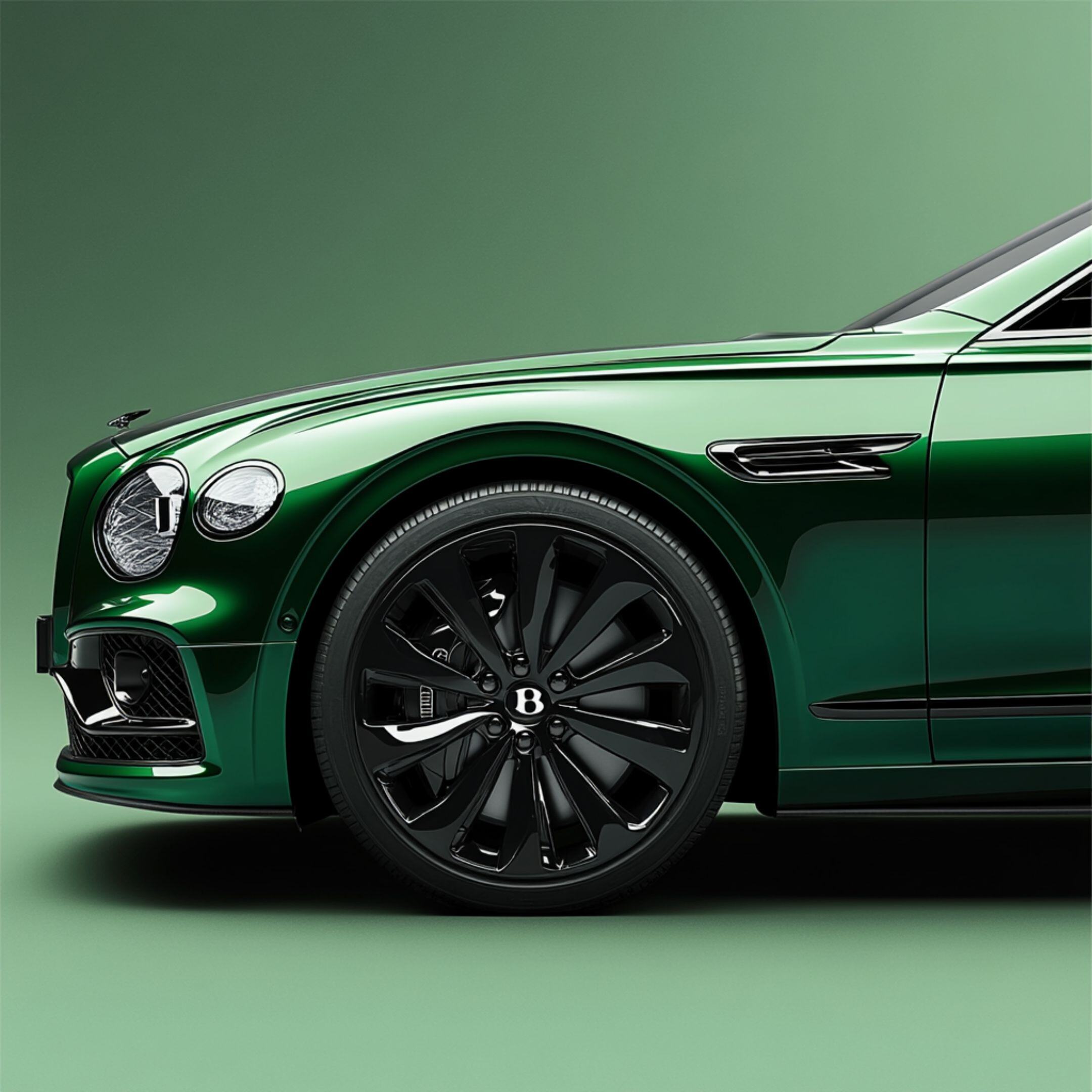 Close up image of the front-end and wheels of a green vintage car on a green background